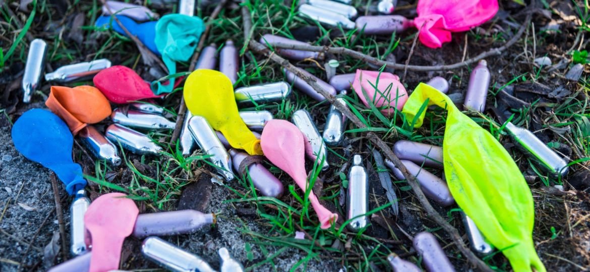 Capsules,Laughing,Gas,And,Balloons,On,Grass,Field