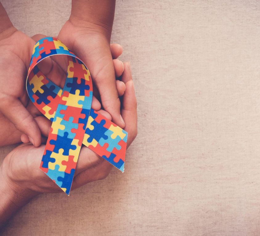 Hands,Holding,Puzzle,Ribbon,For,World,Autism,Spectrum,Disorder,Awareness